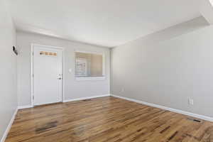 Unfurnished room with wood finished floors