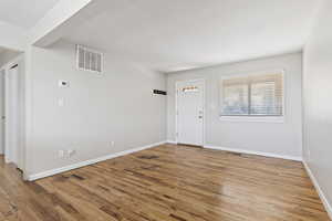 Entrance foyer with light wood-style floors