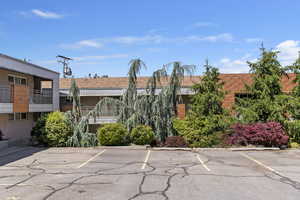 View of property featuring uncovered parking