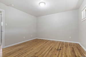 Unfurnished room with a smoke detector and light wood-style floors