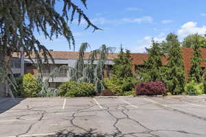 View of property featuring uncovered parking