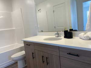 Bathroom with vanity and tub / shower combination