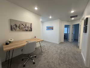 Convenient loft space featuring light colored carpet and recessed lighting