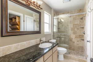 Full bath featuring vanity and a stall shower