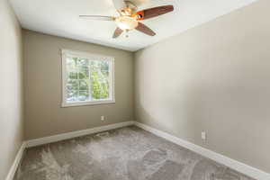 Spare room featuring ceiling fan, carpet floors, and a textured ceiling