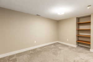 Unfurnished room with carpet flooring and a smoke detector
