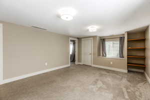 Unfurnished bedroom featuring carpet flooring
