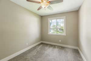 Spare room featuring carpet floors, ceiling fan, and a textured ceiling