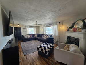 Living area featuring wood finished floors, a fireplace.