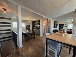 Dining room featuring a textured ceiling and wood finished floors
