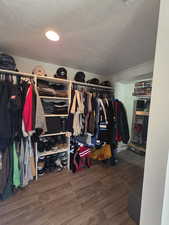 Walk in closet featuring wood finished floors