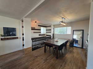 Dining space with wood finished floors and a chandelier