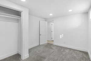 Unfurnished bedroom featuring carpet, recessed lighting, a closet, and a textured ceiling