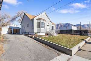 Bungalow-style home with an outdoor structure, a mountain view, and a garage