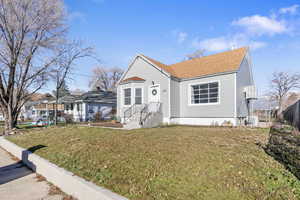 Bungalow-style home with roof with shingles