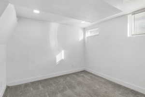 Carpeted empty room with baseboards and a textured ceiling