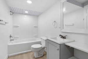 Bathroom featuring vanity, shower / washtub combination, and light wood-style flooring