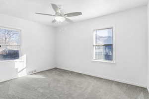Unfurnished room with light carpet and a ceiling fan