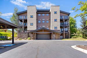 View of apartment building / complex featuring a garage