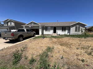 Single story home with an attached garage, concrete driveway, and a shingled roof