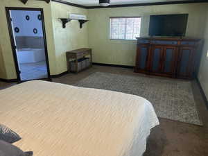 Bedroom featuring crown molding and carpet flooring