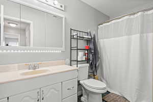 Full bathroom featuring vanity, a shower with shower curtain, and tile patterned floors