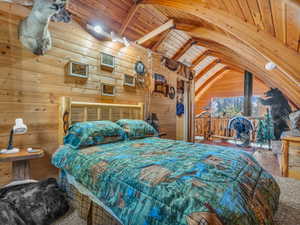 Bedroom featuring wood ceiling, wooden walls, and hardwood / wood-style flooring