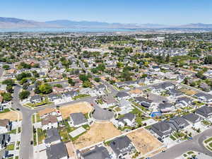 Aerial view of property's location with mountains and nearby suburban area