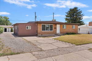 Ranch-style house with brick siding, driveway, and crawl space