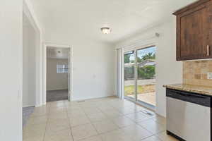 Unfurnished dining area with baseboards and light tile patterned floors