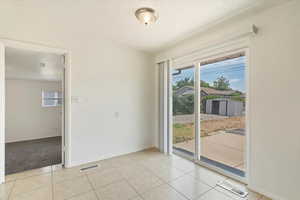 Unfurnished room featuring healthy amount of natural light and light tile patterned floors