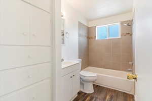Bathroom with vanity, shower / washtub combination, and wood finished floors