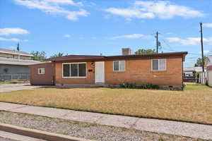 View of front of property with crawl space, brick siding, and driveway