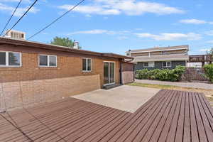 Wooden terrace featuring a patio area