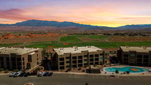 Drone / aerial view of a mountain backdrop and a golf club