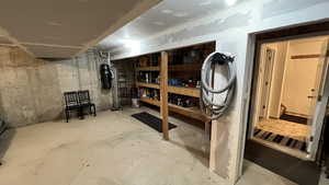 Unfinished basement with a central vacuum unit