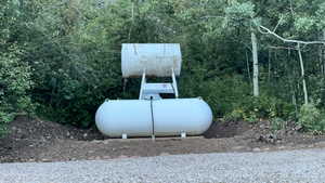 Exterior view of propane tank, and non functional gasoline tank