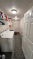 Laundry room featuring independent washer and dryer and half bath