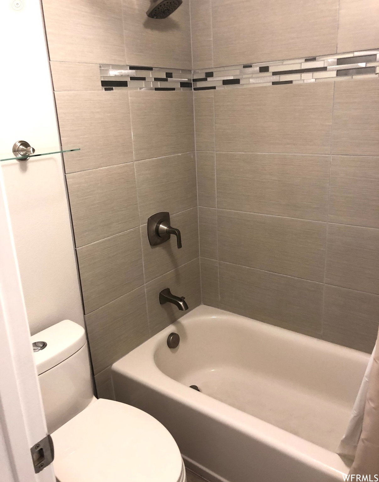 Full bathroom with toilet and shower / washtub combination
