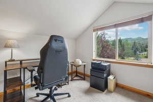 Office featuring lofted ceiling and a mountain view