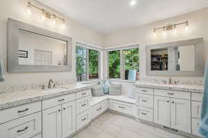 Bathroom with vanity, a walk in closet, and recessed lighting