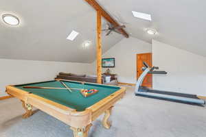Playroom featuring carpet, a skylight, a ceiling fan, and billiards