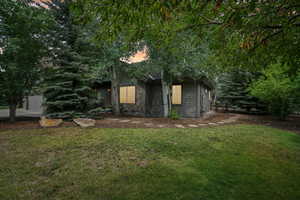 View of front of property featuring a front yard and stone siding