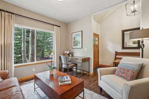 Living room with wood finished floors and a chandelier