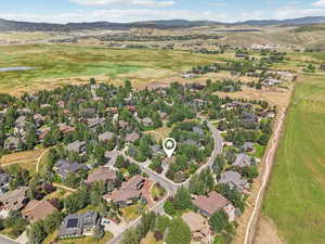 Aerial overview of property's location featuring mountains and nearby suburban area