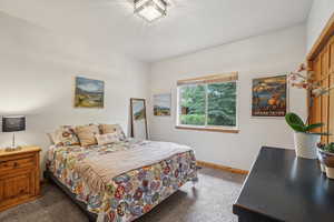 Carpeted bedroom featuring baseboards