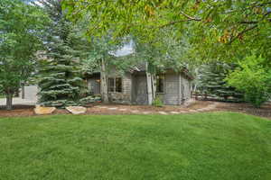 View of grassy yard with an attached garage
