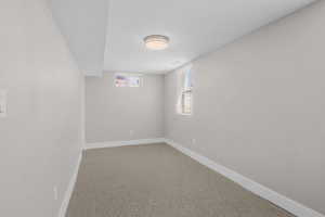 Unfurnished room featuring baseboards and carpet flooring