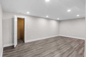 Spare room with wood finished floors and recessed lighting