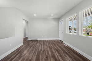 Unfurnished room featuring dark wood-type flooring and recessed lighting